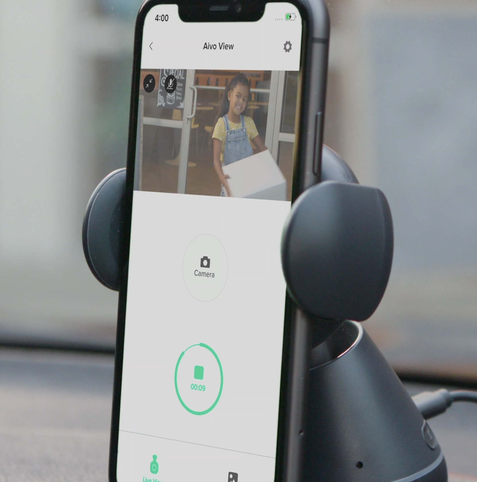 Aivo View app open on a phone mounted in a car, showing a live camera feed