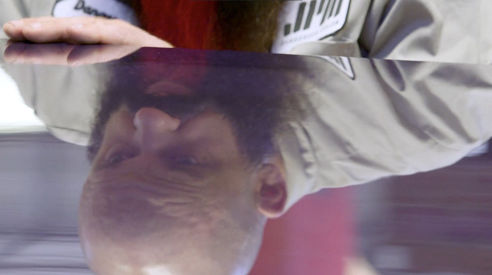 Crew member reflected in a painted tabletop, Dangerous Color