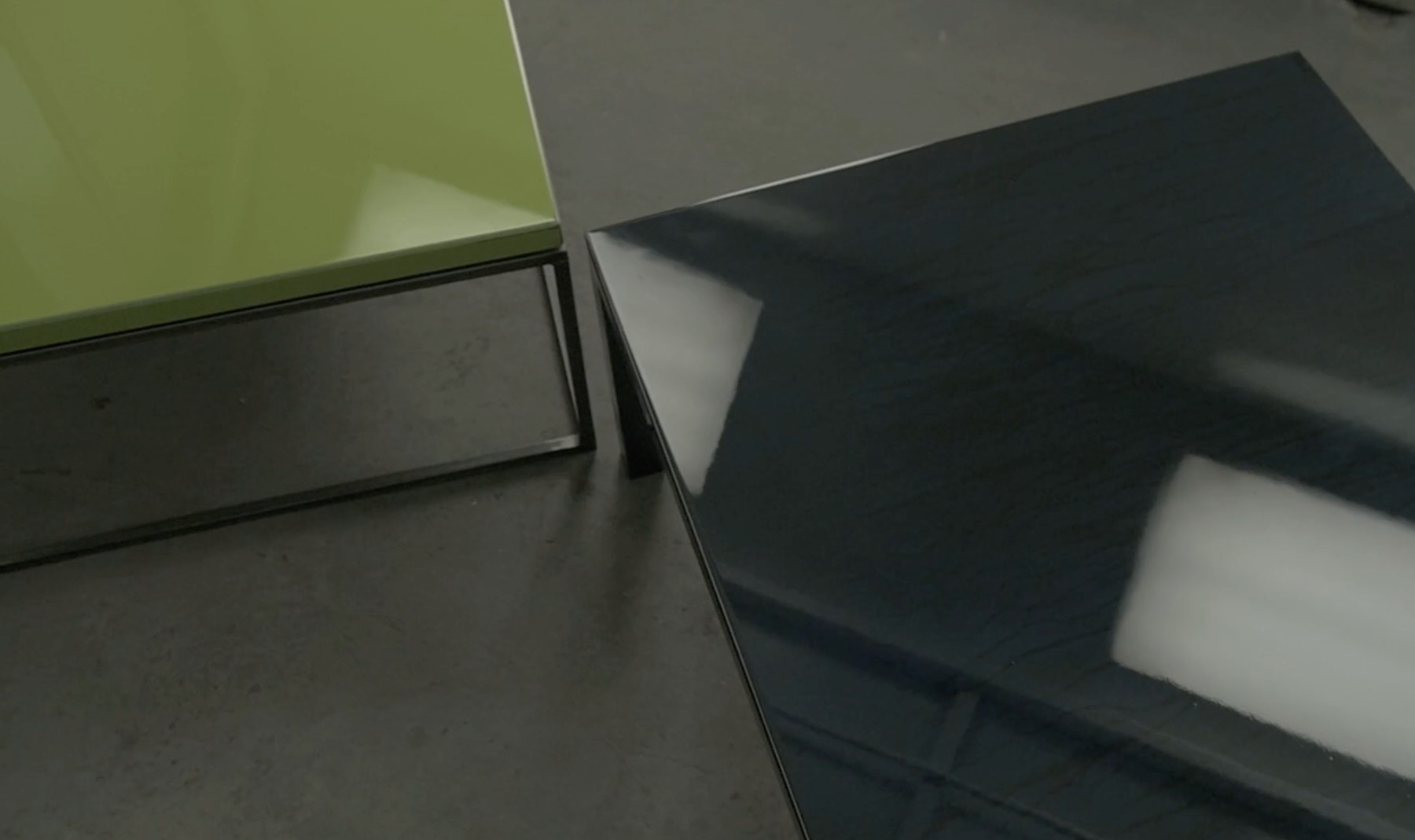 Still from Dangerous Color, glossy painted tables in the studio