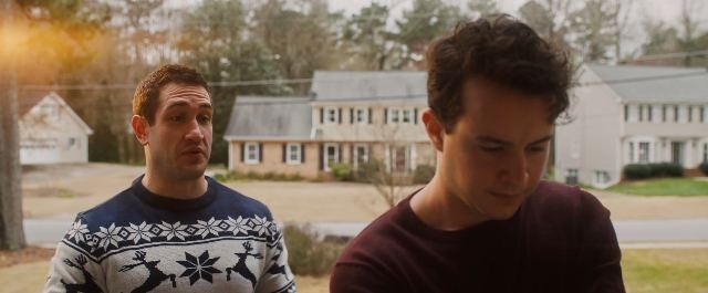 Still from Forgive Us, David and a family member outside the childhood home