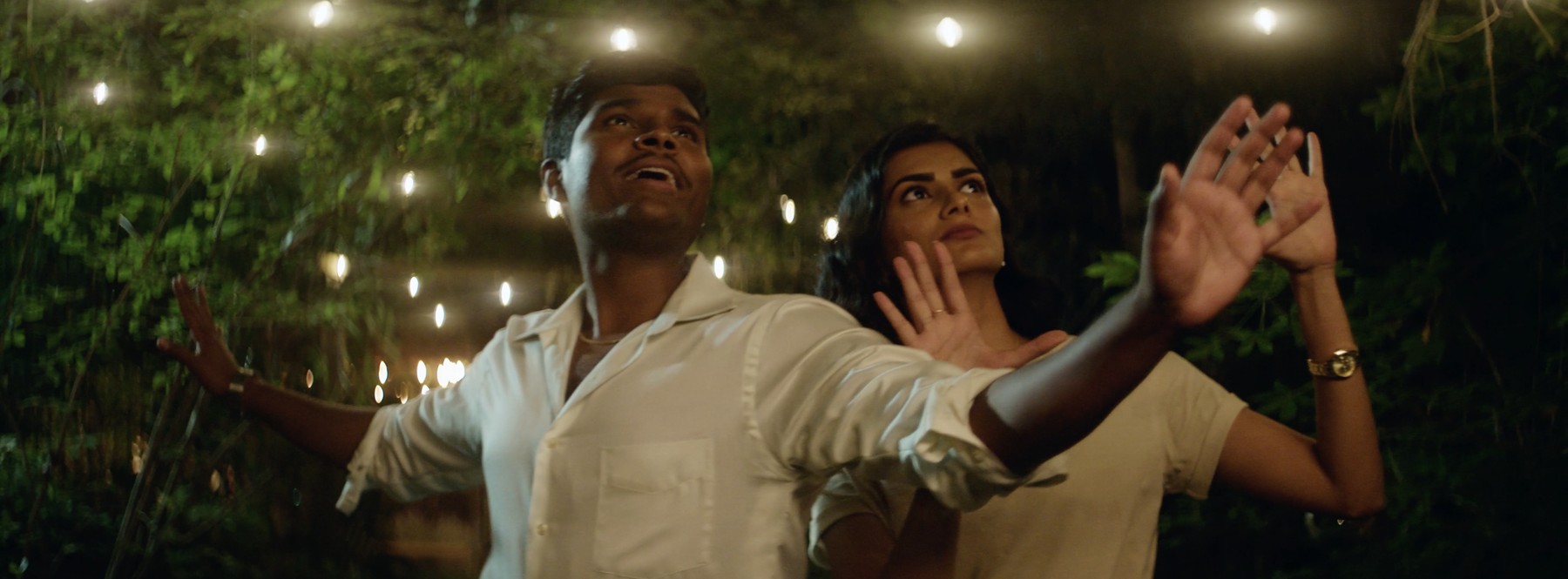 Still from Mysore Magic, a couple under string lights